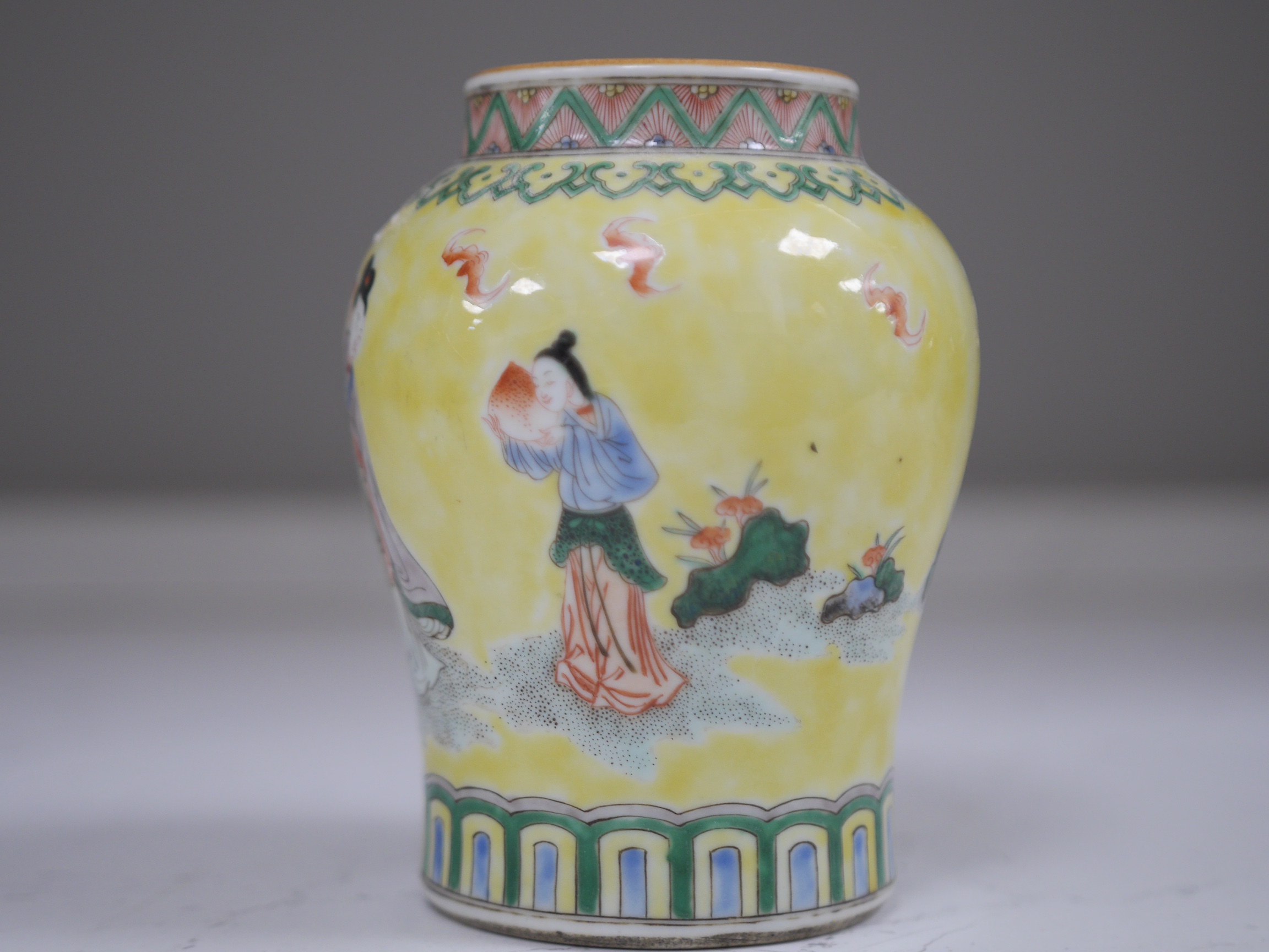 A Chinese yellow ground figurative vase, 15.5cm high. Condition - good